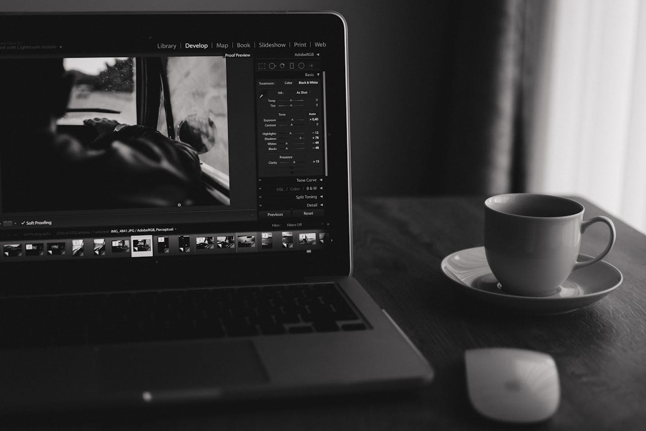 our-story Minimalist black and white photo of a laptop with coffee. Ideal for home office themes.